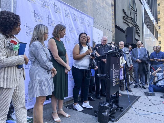 Jennifer, a 44-year-old asylum seeker from Venezuela, speaks at a press conference held outside of Catholic Charities of the Archdiocese of New York.